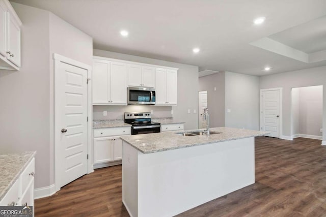 kitchen featuring stainless steel appliances, white cabinets, a center island with sink, and sink