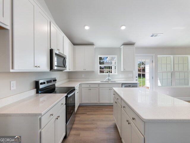 kitchen featuring sink, white cabinets, and appliances with stainless steel finishes