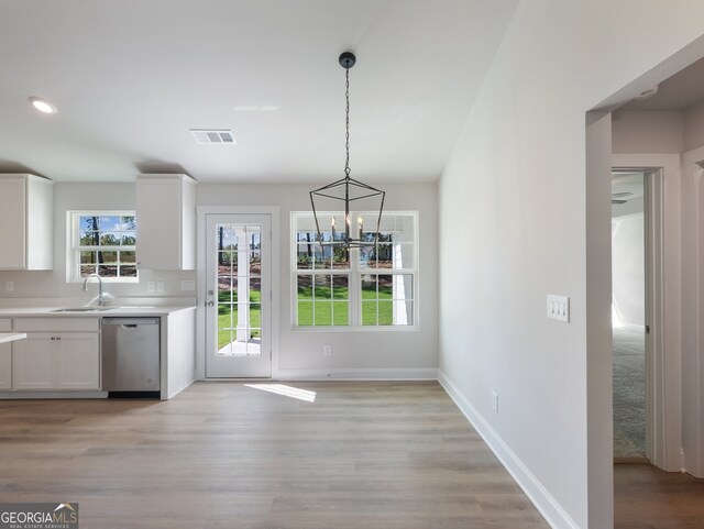 interior space featuring a notable chandelier, light wood-type flooring, and sink