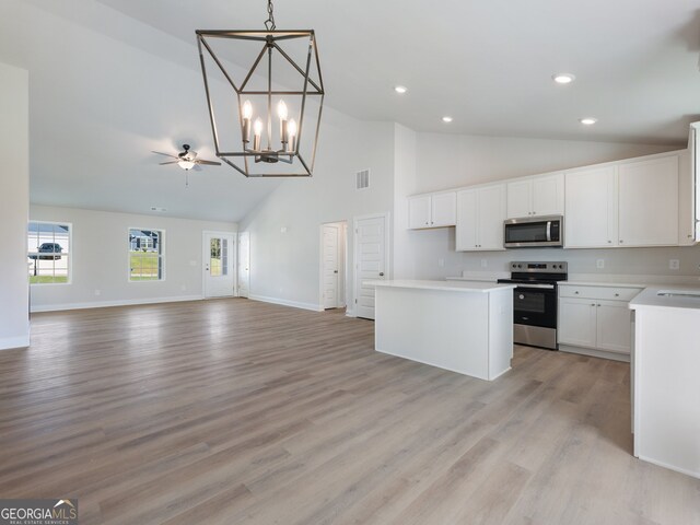 kitchen featuring white cabinets, a center island, stainless steel appliances, and light hardwood / wood-style flooring