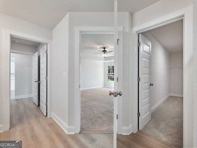 hallway with light hardwood / wood-style floors