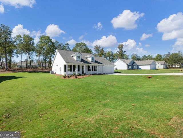 cape cod-style house featuring a front lawn and cooling unit