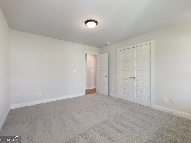 unfurnished bedroom featuring a closet and carpet