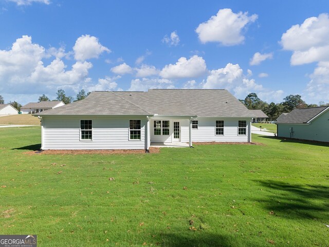 rear view of house with a yard