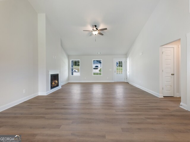 unfurnished living room with ceiling fan and dark hardwood / wood-style flooring