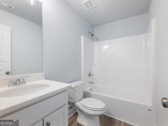 full bathroom with vanity, toilet, wood-type flooring, and shower / tub combination