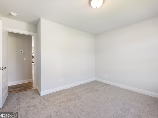 empty room featuring light carpet