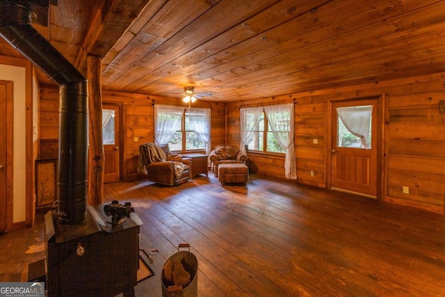 unfurnished room featuring ceiling fan, wood walls, hardwood / wood-style floors, and wooden ceiling