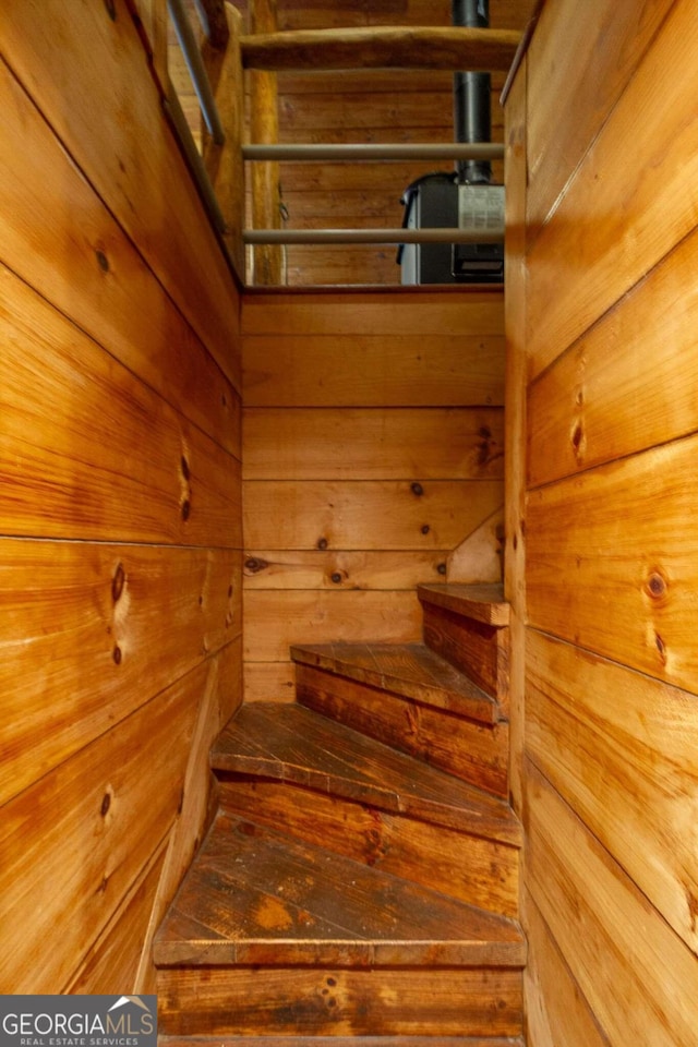 staircase with wood walls