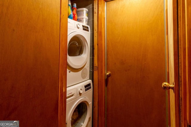 clothes washing area with stacked washer / dryer