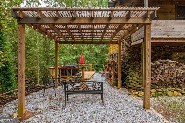 view of patio featuring a pergola and an outdoor fire pit