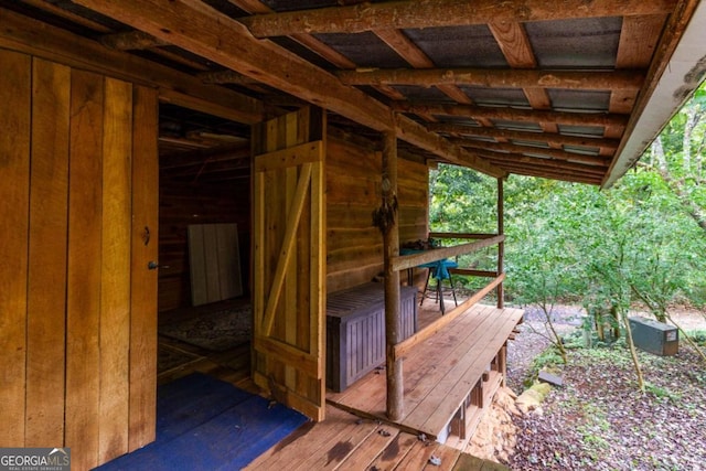 exterior space with wooden walls and hardwood / wood-style flooring