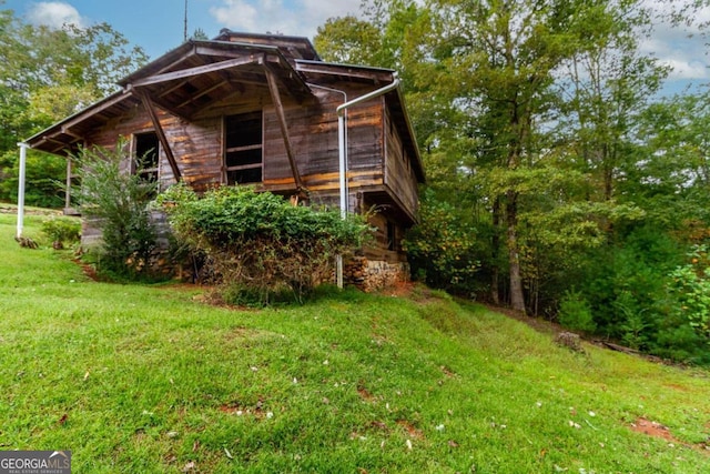 view of home's exterior with a lawn