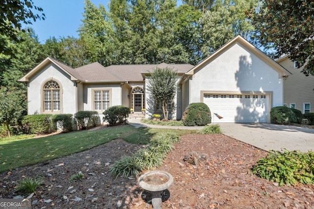 view of front of home featuring a front yard and a garage