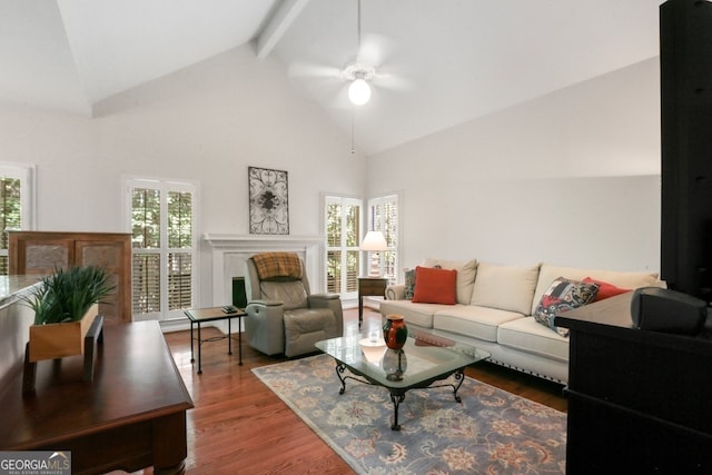 living room featuring ceiling fan, beamed ceiling, plenty of natural light, and hardwood / wood-style floors