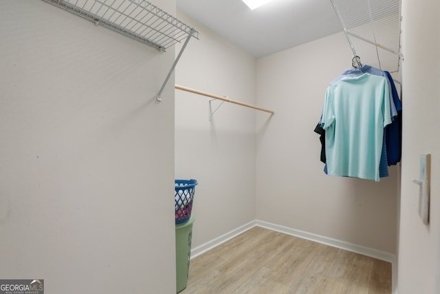 spacious closet featuring hardwood / wood-style flooring