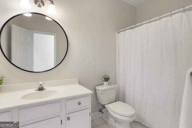 bathroom featuring tile patterned flooring, toilet, and vanity