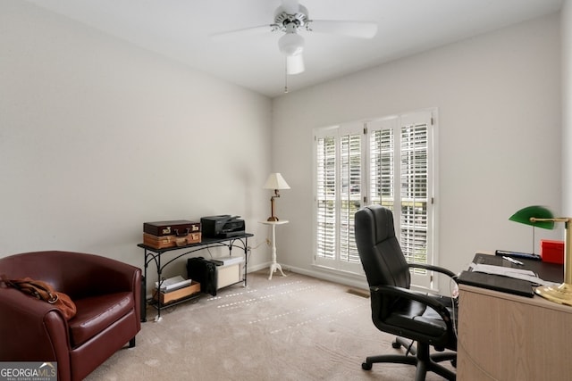 home office featuring ceiling fan and light colored carpet