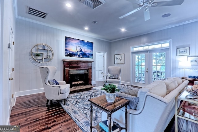 living room with wood-type flooring, french doors, ornamental molding, and ceiling fan