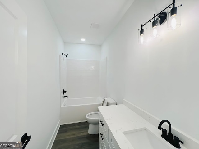 full bath featuring toilet, vanity, wood finished floors,  shower combination, and baseboards