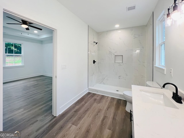 full bath featuring toilet, wood finished floors, visible vents, vanity, and baseboards