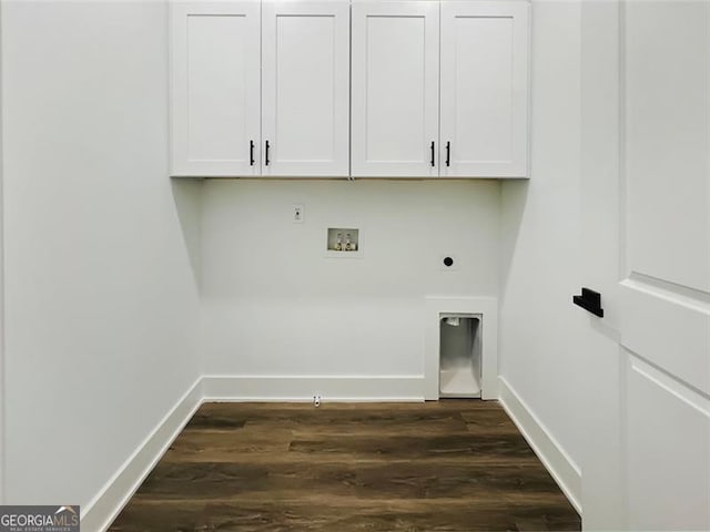 clothes washing area featuring hookup for an electric dryer, washer hookup, baseboards, cabinet space, and dark wood-style floors