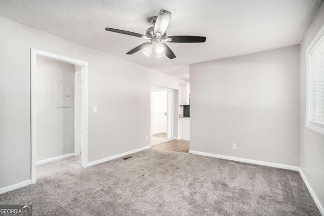 unfurnished room featuring visible vents, a ceiling fan, baseboards, and carpet floors