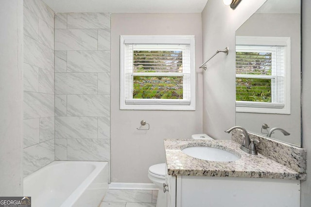 bathroom featuring marble finish floor, a wealth of natural light, toilet, and vanity