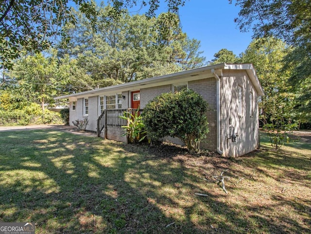 view of front of house with a storage unit and a front yard