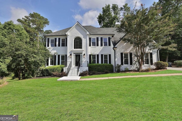 colonial house featuring a front lawn