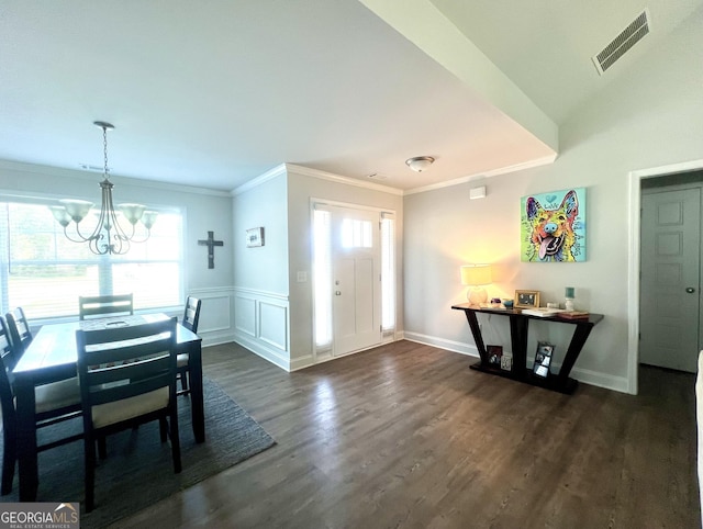 dining space with ornamental molding, plenty of natural light, dark hardwood / wood-style flooring, and a chandelier