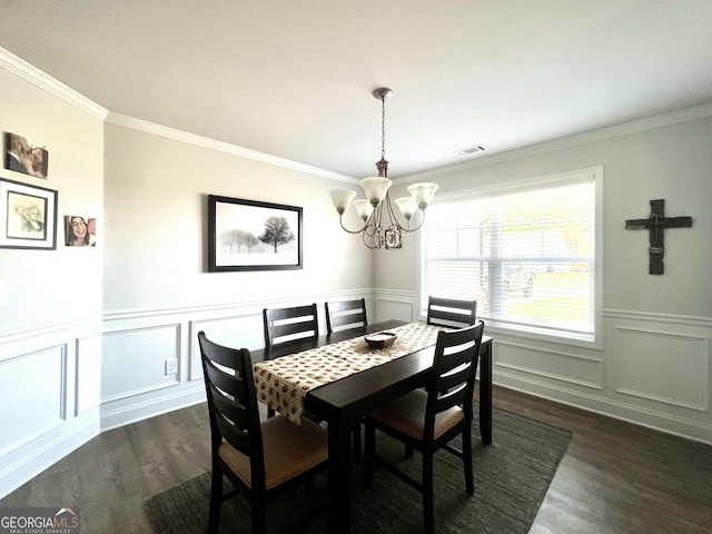 dining space with an inviting chandelier, crown molding, and dark hardwood / wood-style flooring