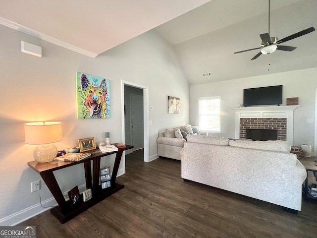 living room with lofted ceiling, a fireplace, dark hardwood / wood-style floors, and ceiling fan