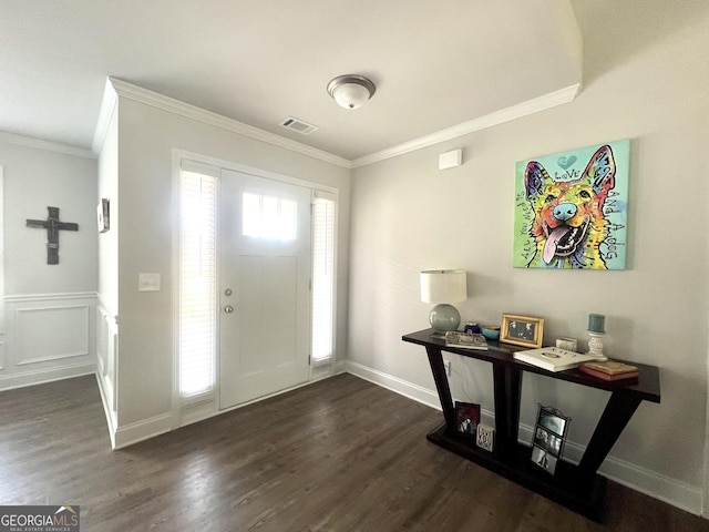 entrance foyer featuring ornamental molding and dark hardwood / wood-style floors