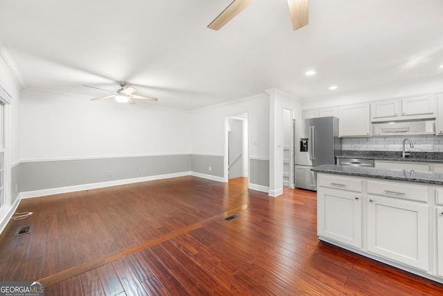 kitchen featuring white cabinets, stainless steel appliances, dark hardwood / wood-style floors, and ornamental molding