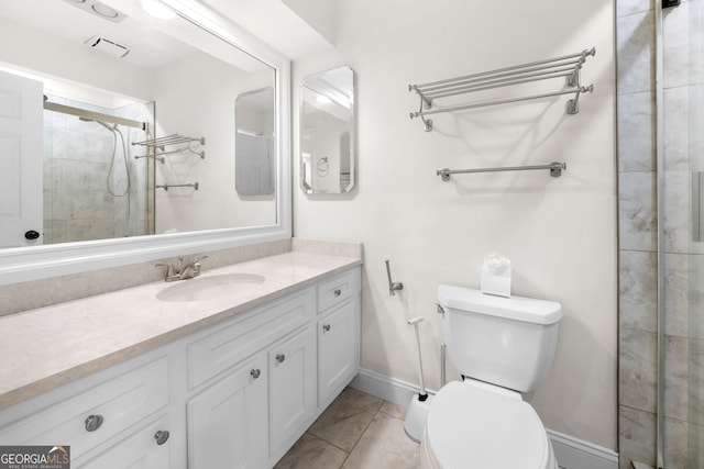 bathroom with a shower with door, vanity, and toilet