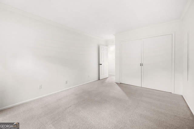 unfurnished bedroom featuring light carpet, a closet, and crown molding