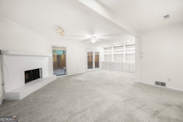 unfurnished living room with crown molding, carpet flooring, ceiling fan, and a brick fireplace