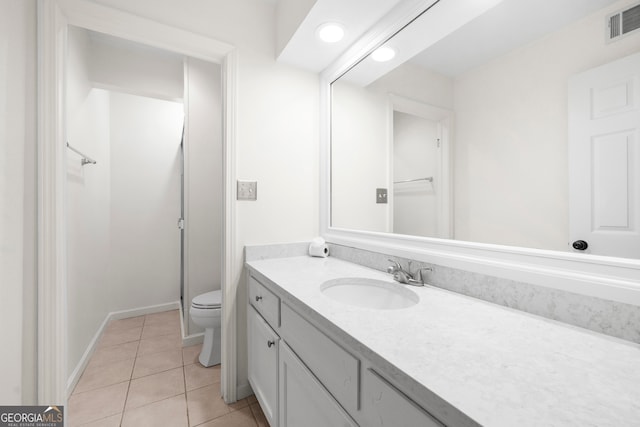 bathroom featuring vanity, toilet, and tile patterned floors