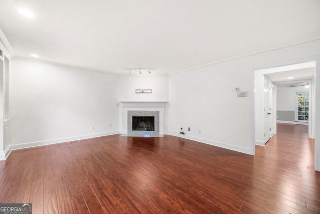 unfurnished living room featuring ornamental molding and hardwood / wood-style floors