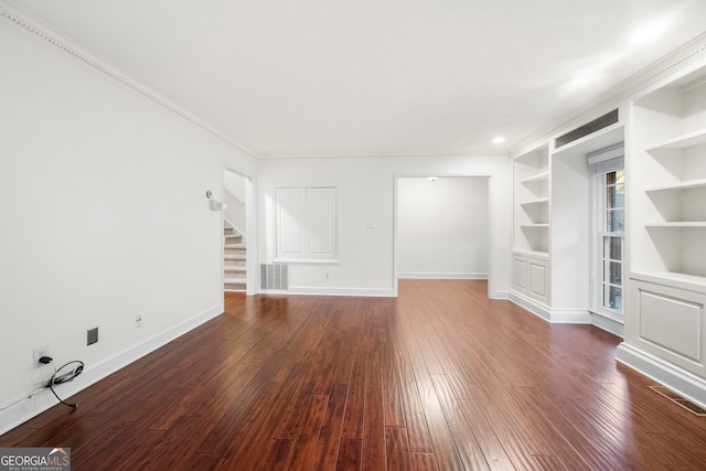 unfurnished living room featuring built in shelves, dark wood-type flooring, and crown molding