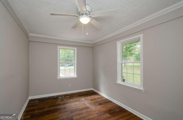 empty room with ceiling fan, crown molding, dark wood-type flooring, and a healthy amount of sunlight