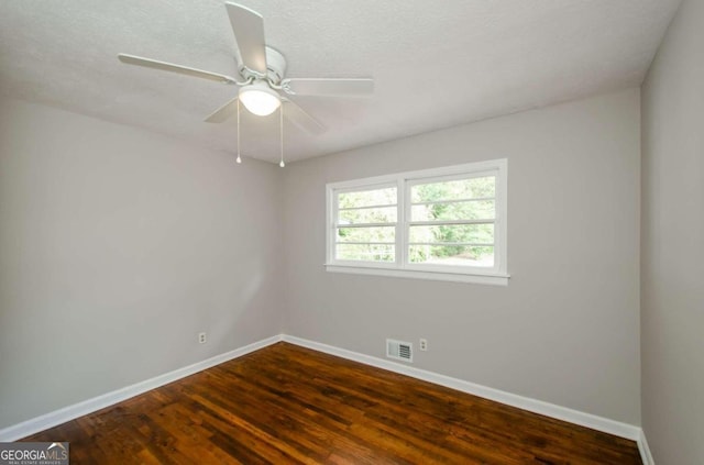 spare room with a textured ceiling, dark hardwood / wood-style floors, and ceiling fan