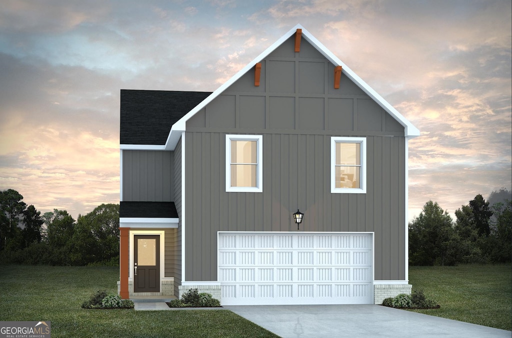 view of front of home with a yard and a garage