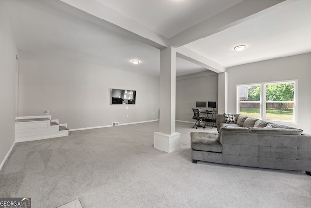 living area with carpet, visible vents, baseboards, and beamed ceiling