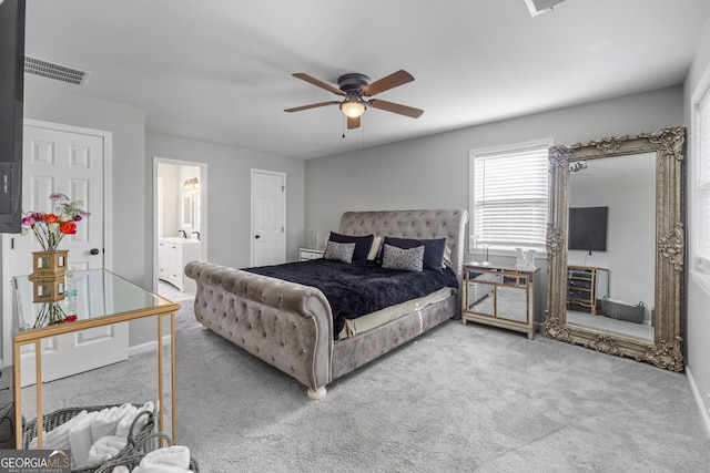 bedroom featuring ensuite bath, carpet, visible vents, and ceiling fan