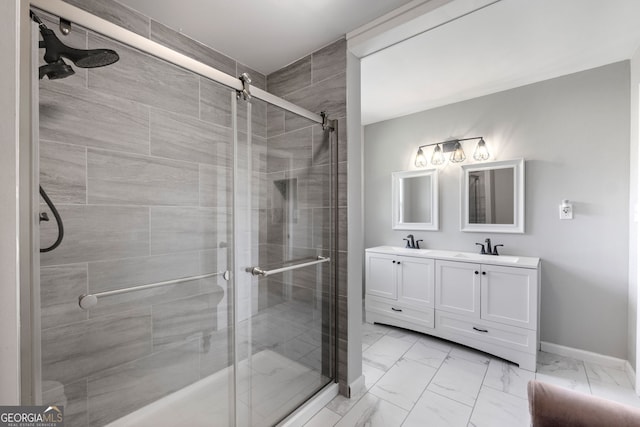 bathroom featuring marble finish floor, a sink, and a shower stall