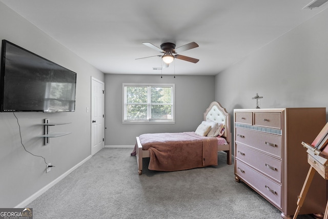 bedroom with baseboards, visible vents, a ceiling fan, and light colored carpet