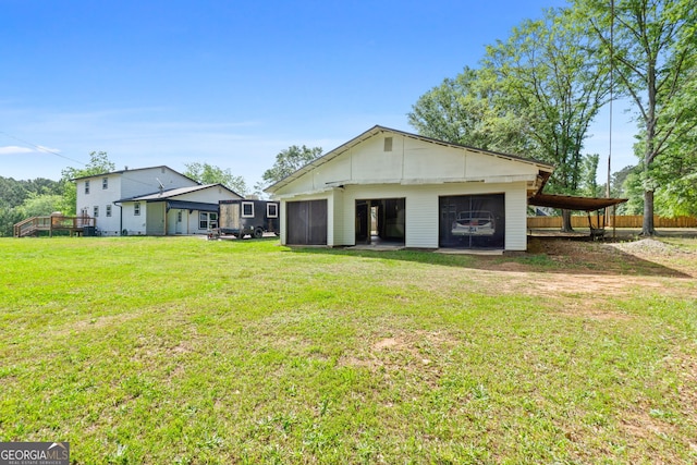 back of house featuring a yard and an outdoor structure