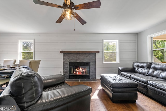 living room with a fireplace and dark wood finished floors